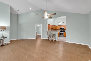 Unfurnished living room with ceiling fan, high vaulted ceiling, and light hardwood / wood-style floors