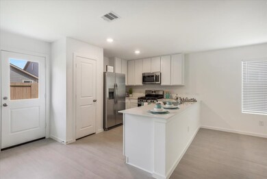 The gourmet kitchen is equipped with gas range, mi
