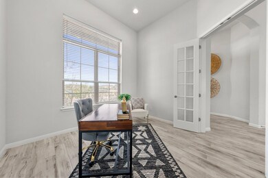 Office with light wood finished floors, baseboard