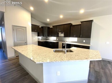 Kitchen featuring backsplash, light stone countert
