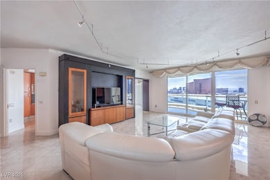 Living area featuring baseboards and rail lighting