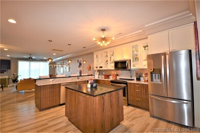 Kitchen has added island plus stainless steep appl
