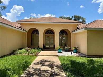 Doorway to property with french doors, a shingled roof, and stucco siding