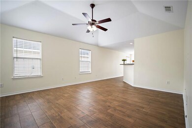 Unfurnished room with ceiling fan, lofted ceiling,