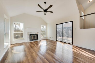 Unfurnished living room featuring ceiling fan, a h