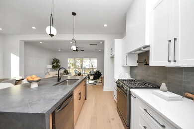 The custom vent hood above the gas range adds a un