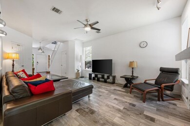 Living room featuring ceiling fan, wood finished 