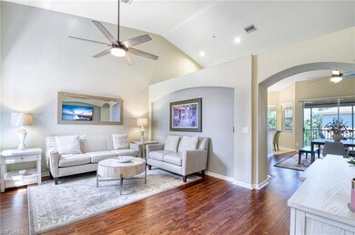 Living area featuring ceiling fan, arched walkways