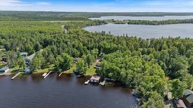 View of property location featuring a forest and a nearby body of water