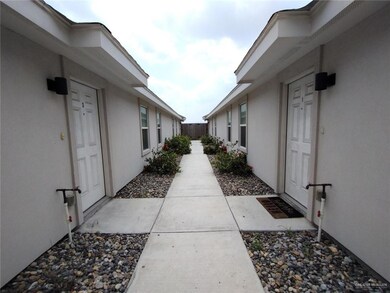 View of side of property with stucco siding and fence