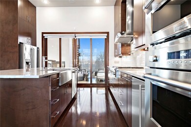 High-end appliances, granite countertops, double ovens, and an ice maker are a few features of the kitchen.