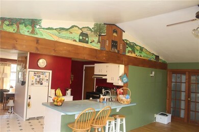 Kitchen with stainless appliances, tile floor, pen