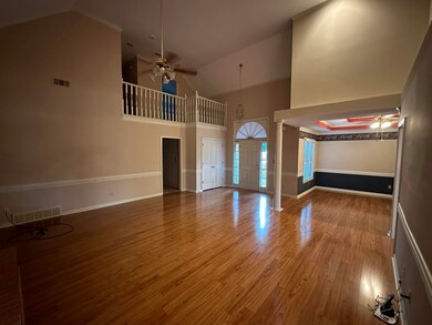 Unfurnished living room with high vaulted ceiling,