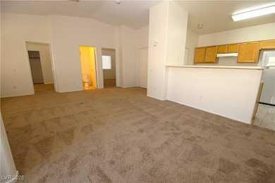 Unfurnished living room featuring lofted ceiling a