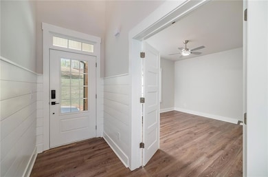 Doorway to outside featuring a ceiling fan and woo