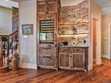 Wine bar with two beverage drawers, a wine refrigerator and storage area. Two half baths off the kitchen. One half bath with door to the pool.