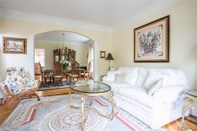 Living room with arched opening to dining room