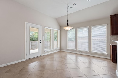 Unfurnished dining area with vaulted ceiling, lig