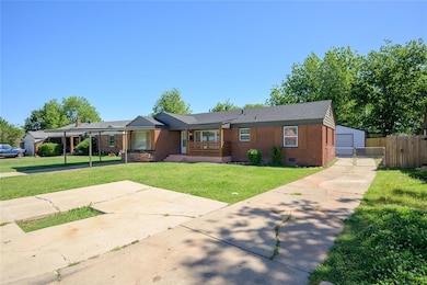 View of front of house with a porch, concrete driveway, an attached carport, and brick siding
