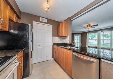 Utility Room With Full Size Washer/Dryer Behind Do