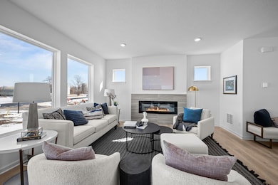 Living room with electric fireplace and large windows