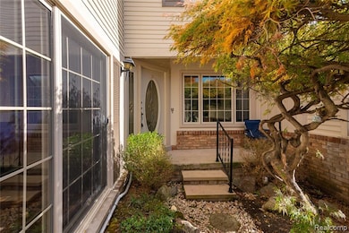 View of exterior entry with brick siding