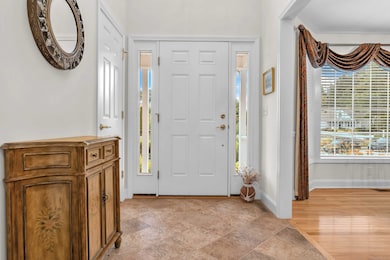 Natural light pours into this grand foyer with impressive vaulted ceilings