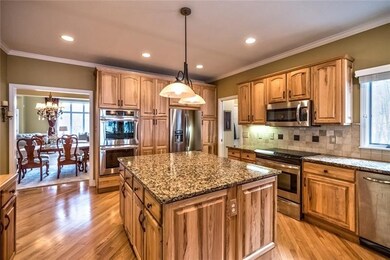 Warm and inviting center island kitchen has beauti