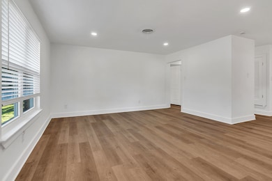 Living room featuring healthy amount of natural light, recessed lighting, and light wood-style flooring