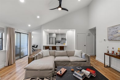 Living room with ceiling fan, high vaulted ceiling, recessed lighting, and light wood finished floors