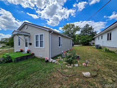 View of property exterior featuring a yard and a cooling unit