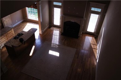 Open living room with soaring ceiling and fireplace with gas logs