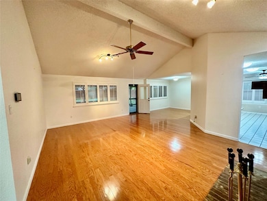 Vaulted ceiling in family room with hardwood floors