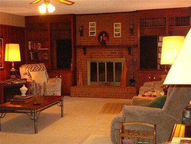 Den offers extensive built-ins and a brick firepla