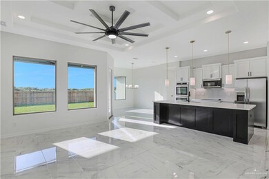Full bathroom featuring recessed lighting, marble finish floor, coffered ceiling, tasteful backsplash, and ceiling fan with notable chandelier