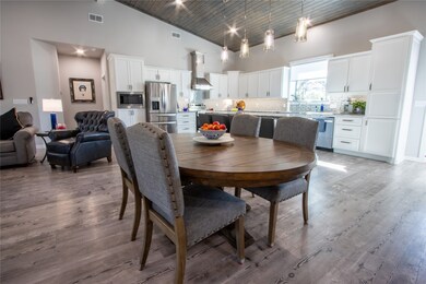 Dining area with high vaulted ceiling, wooden ceiling, and light wood finished floors