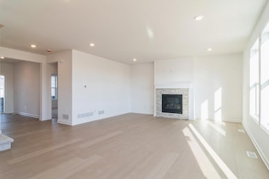 (*Photo of similar home, actual homes colors and finishes will vary) The cozy fireplace is a beautiful focal point in the Great Room