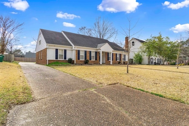 View of front of house with a front yard, fence, b