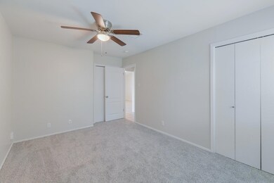 Unfurnished bedroom with carpet flooring, baseboa