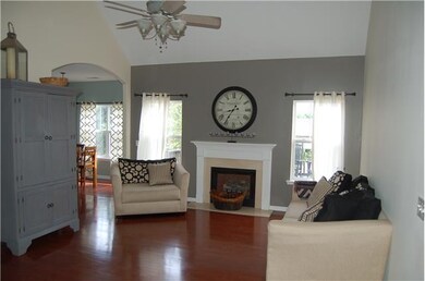 Open living room with vaulted ceiling and fireplac