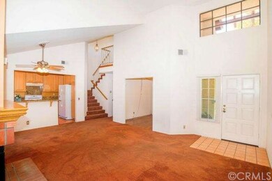 Vaulted ceiling living room with ceiling fan and l