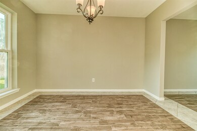Tile floor with beautiful ceramic wood look tile inlays, and lots of natural light in the dining room