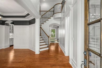 Open double height entry foyer; dining to left; office to right