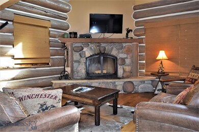 Main level living area with wood fireplace.