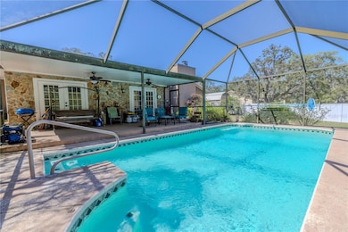 The heated swimming salt water pool sits beneath a screen enclosure.