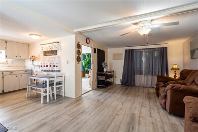 Living room featuring light wood-style vinyl flooring and natural light