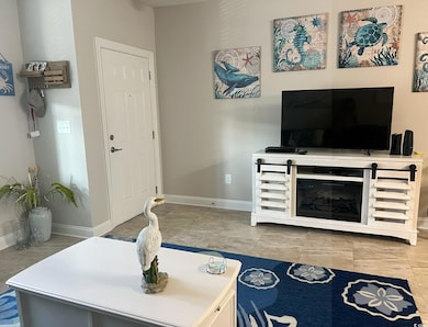 Living area featuring light tile patterned floors