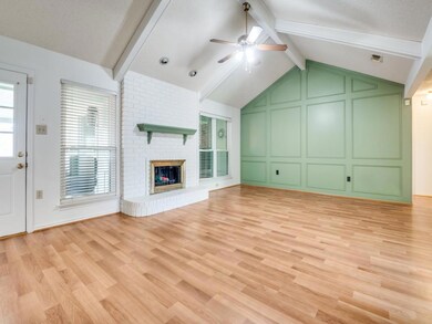 Unfurnished living room featuring a decorative wal