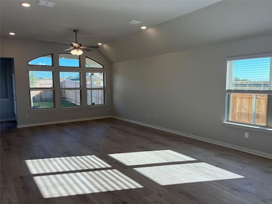 Empty room featuring vaulted ceiling, dark wood-style floors, ceiling fan, and recessed lighting