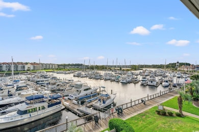 Dock featuring view of marina and a water view